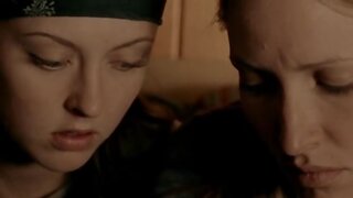 Katharine Isabelle and Michelle Nolden kissing each other in Show Me