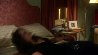 Julia Louis-Dreyfus taking off her bra from under her shirt