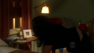 Julia Louis-Dreyfus taking off her bra from under her shirt
